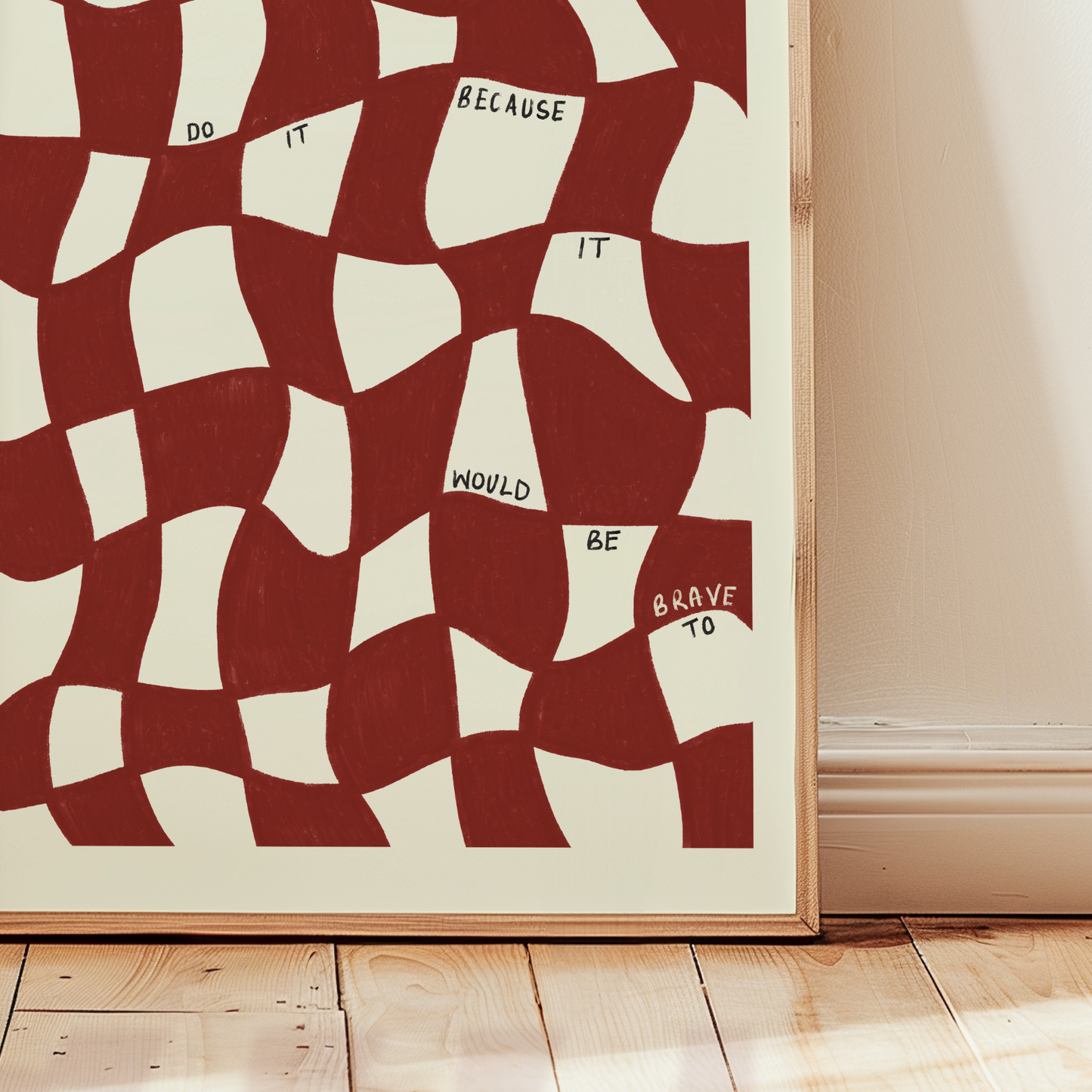 Framed abstract art print with red and white pattern on a light wall.