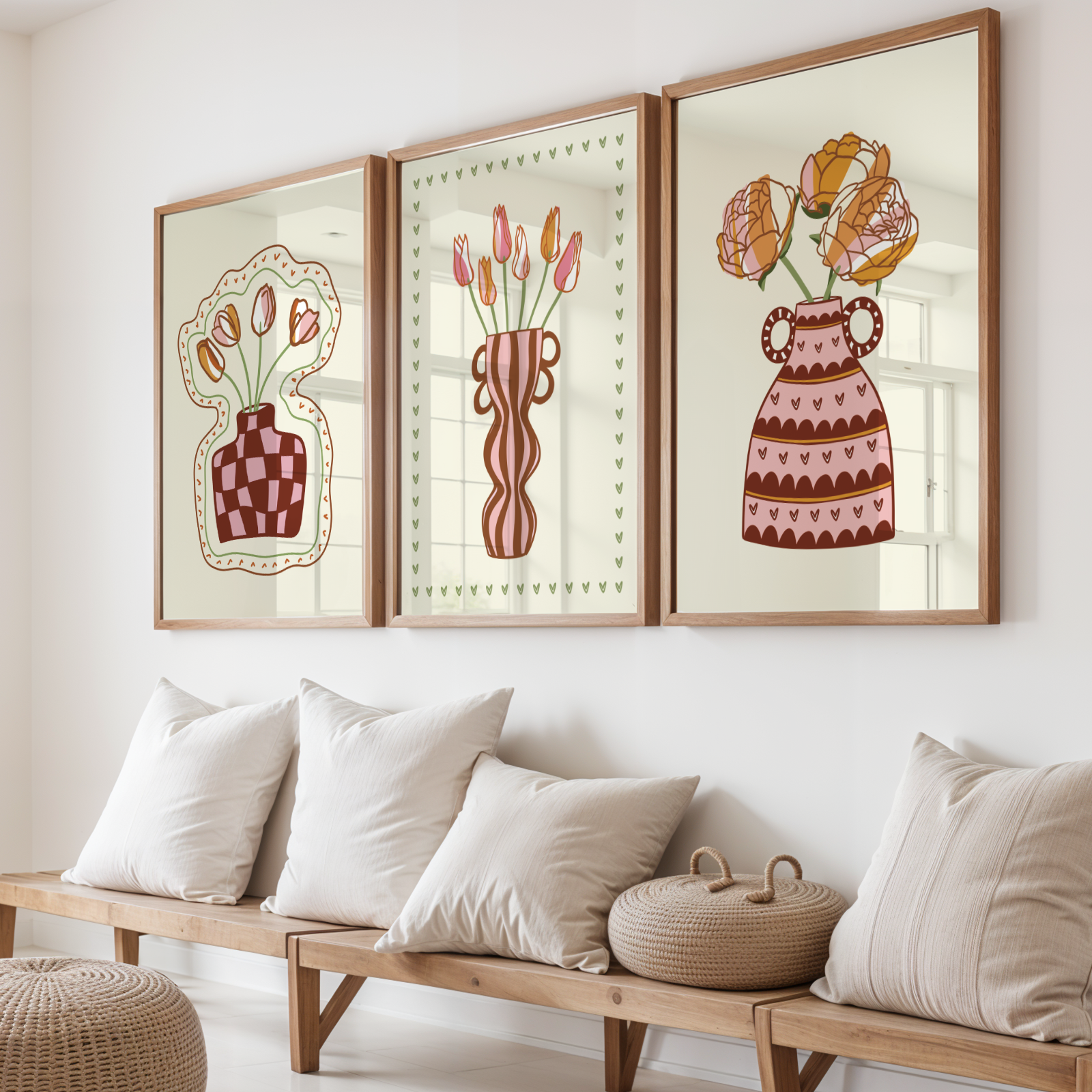 Three framed artworks of floral vases on a wall above a wooden bench with cushions.